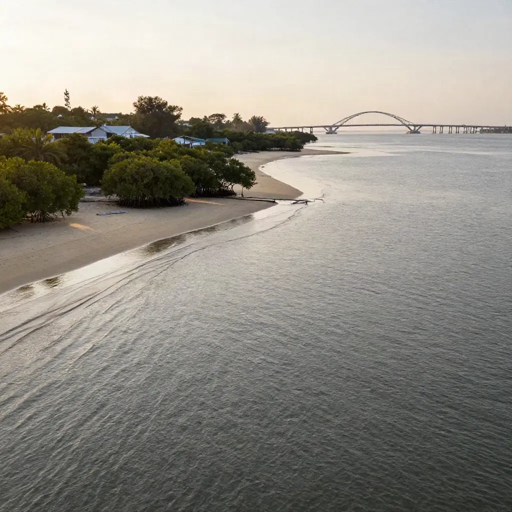 Pemandangan pesisir Johor Selatan dengan jambatan jauh, bakau, air tenang dan cahaya keemasan.